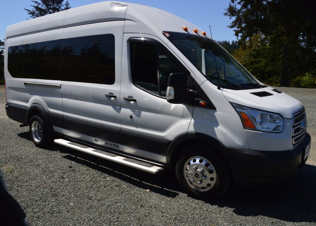 White Ford Transit shuttle van